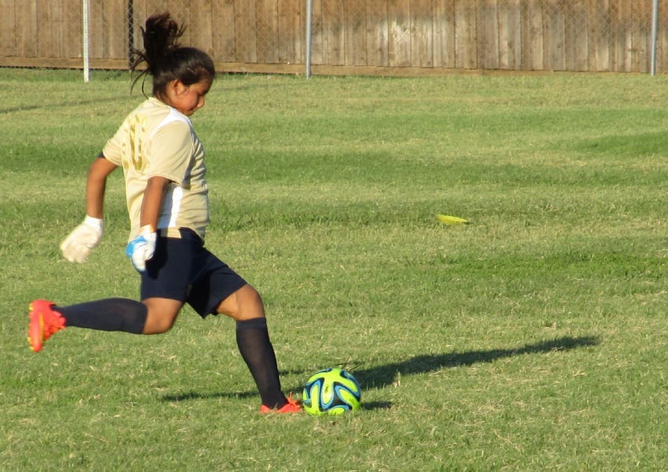 Girl Playing Football wearing Uniform